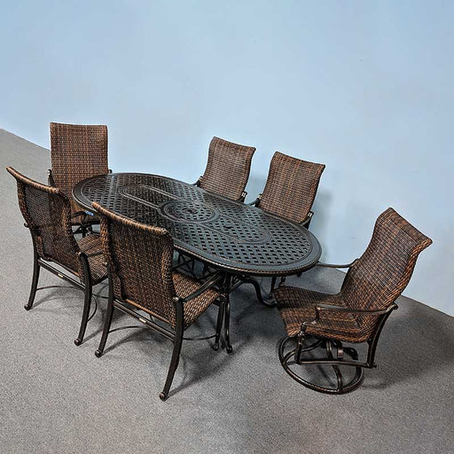 86" Oval outdoor dining table surrounded by 6 woven dining chairs