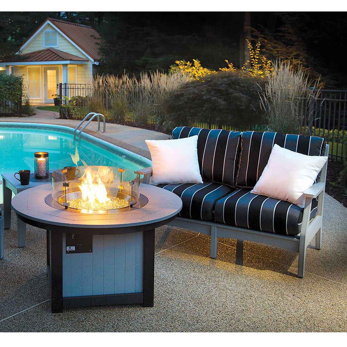 Grey Poly Lumber Love Seat with blue and black stripes by a swimming pool and fireplace