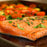 Salmon topped with cilantro grilling on a Stainless Steel Griddle